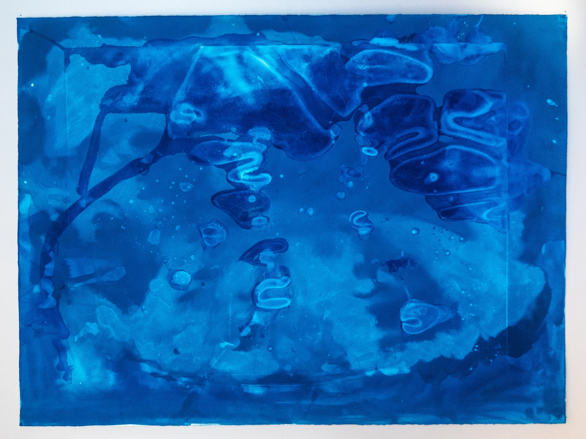 Flowing organic shapes and S-curves in light blue against deep Prussian blue, like floes carried on a current.
