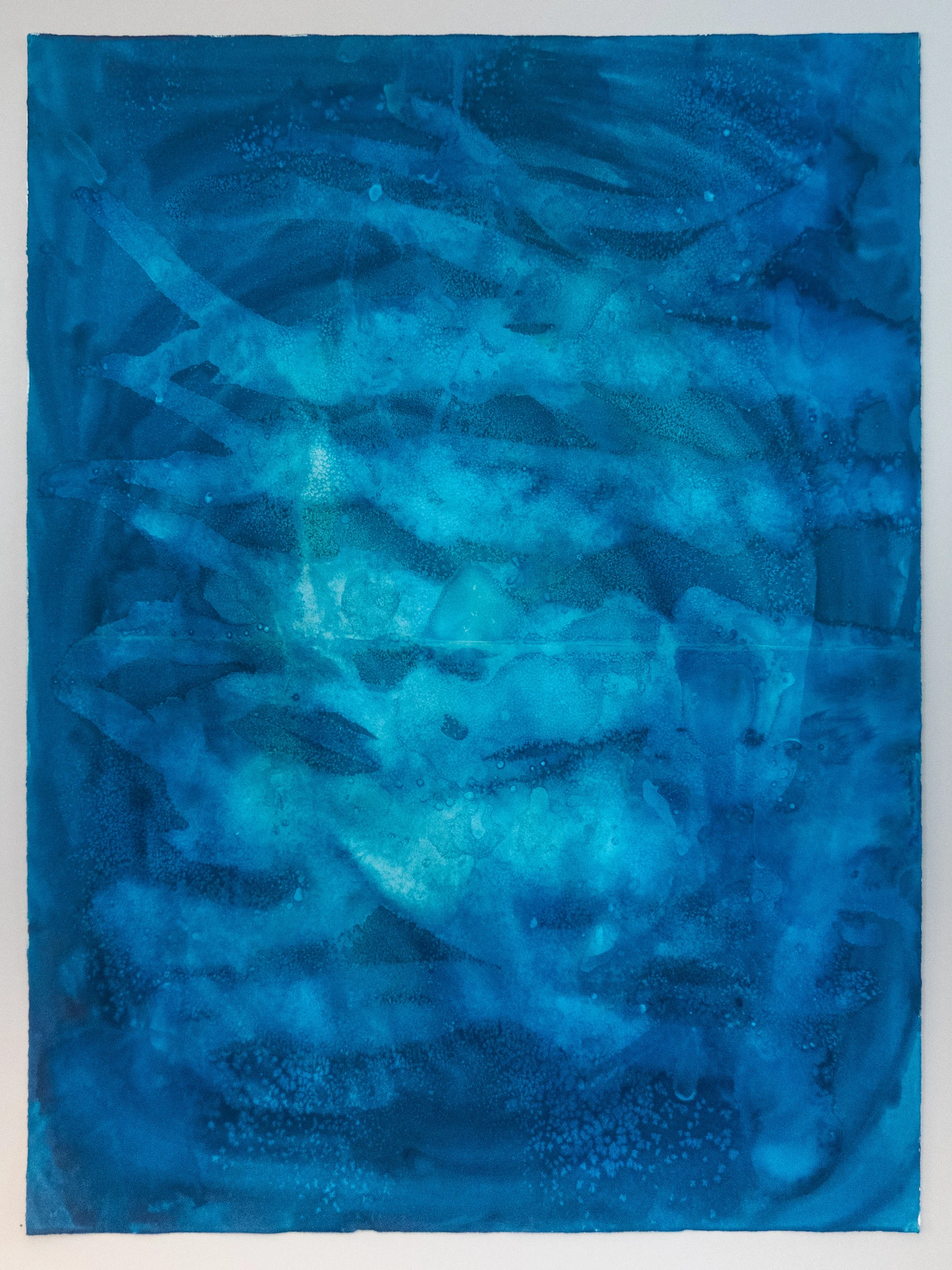 Vertical striations of deep blue broken by shafts of lighter tone, light filtering down as if through a standing bed of kelp.
